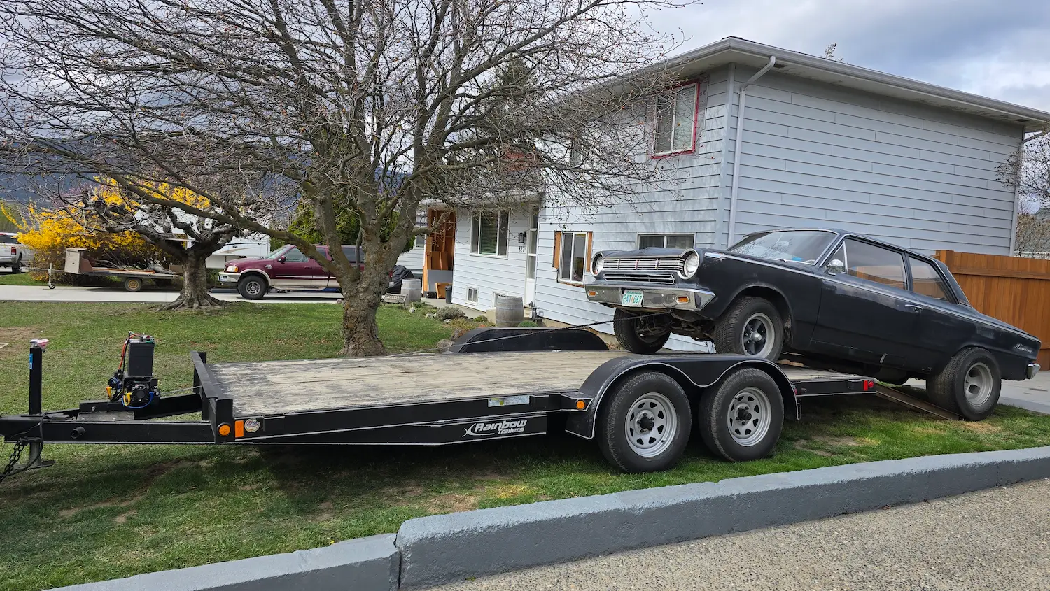 rambler Classic car being loaded on a flatbed trailer